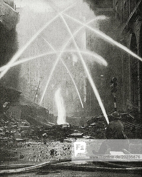 Firemen tackle a city blaze after a bombing raid on London in 1940 during WWII. From The War in Pictures  Second Year.