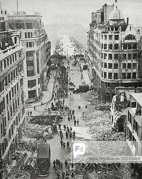 The approach to London Bridge after a German bombing attack  September 1940. Civilians making their way to work amongst the rubble. From The War in Pictures  Sixth Year.