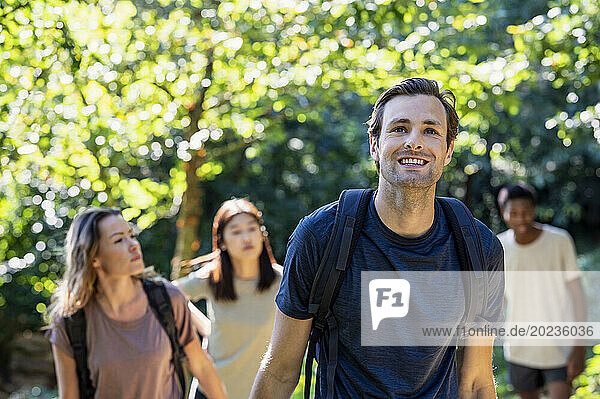 Young adult man having fun during hiking excursion with friends
