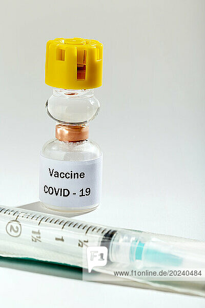 Medical Vaccine COVID-19 vial and syringe on a white background with spotlight effect; Studio