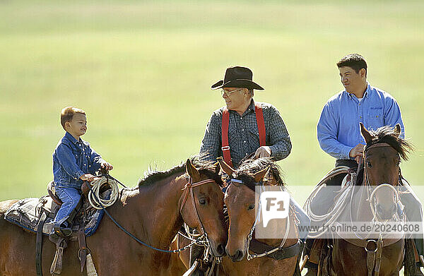 Rancher  his son and grandson on horseback; Howes  South Dakota  United States of America