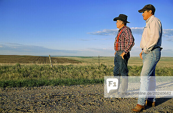 Father and son together on their ranch; Howes  South Dakota  United States of America