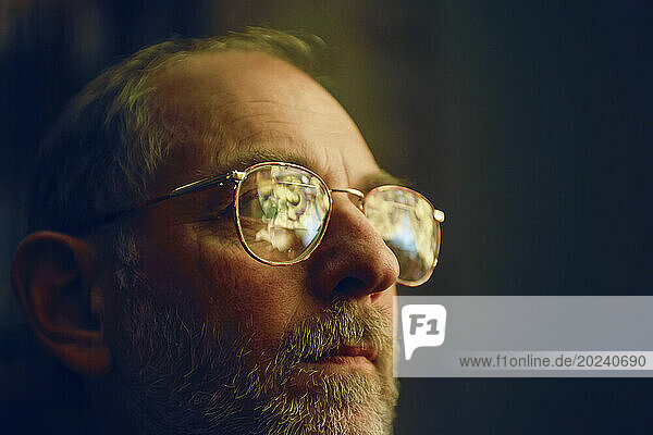Man in glasses with stained glass windows reflected in them; Lincoln  Nebraska  United States of America