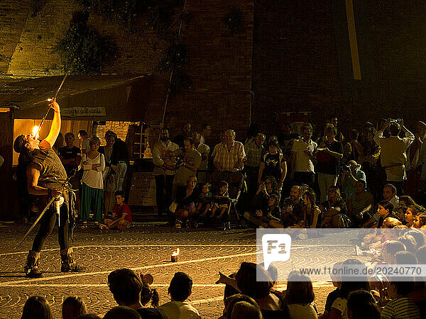Fire eater entertaining people at night  medieval reenactment; Grottazzolina  Fermo province  Marche  Italy