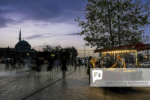 Suleymaniye Mosque in silhouette and corn street vendor in Eminonu Square  Istanbul; Istanbul  Turkey