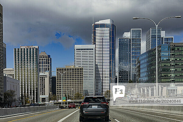 Cars on the road driving through Seattle  Washington  with a view of residential and office buildings; Seattle  Washington  United States of America