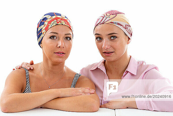 Portrait of two young women undergoing chemotherapy treatment.