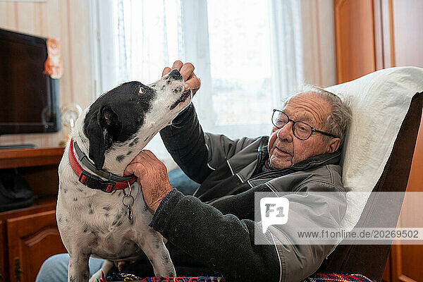 90 year old senior living with his dog.