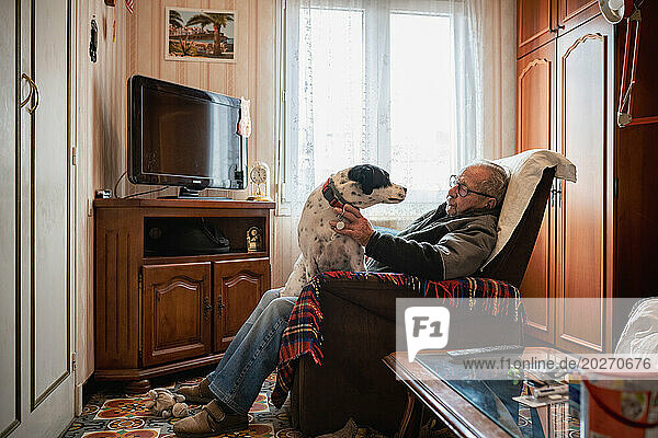 90 year old senior living at home with his dog.