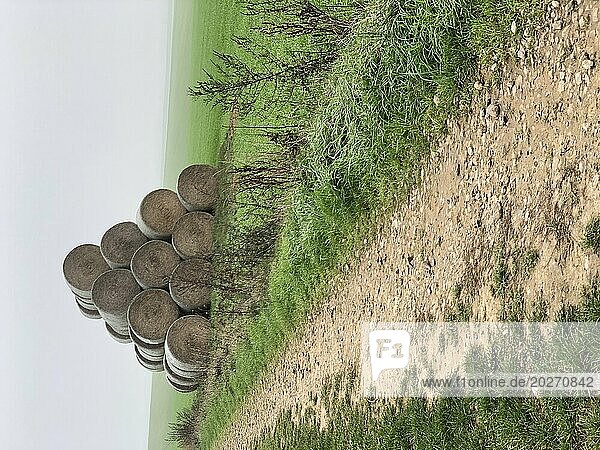 Hay rolls along a rural road in Hauts-de-France