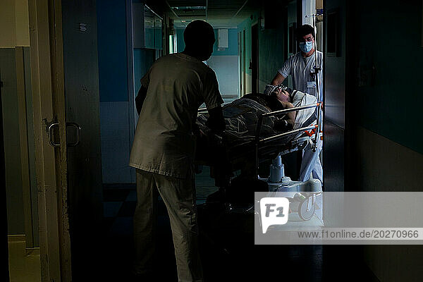 Transporting a patient on a stretcher in the emergency room of a university hospital.