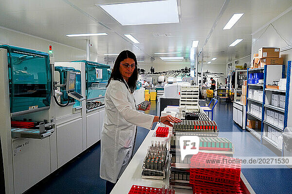 Technical platform of the Inovie 34 laboratory . Technician organizing her workstation.