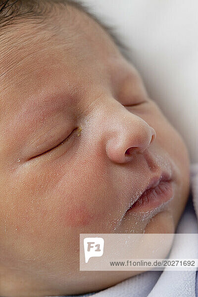 Sleeping newborn face at 1 day old.