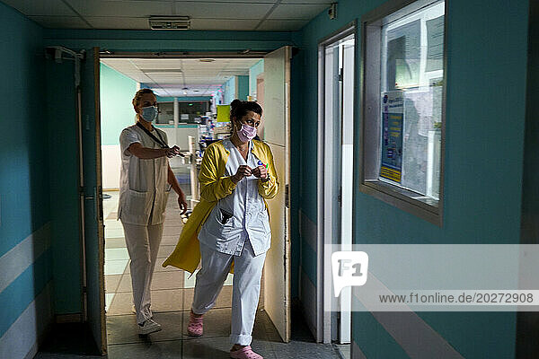 Hospital staff in a hallway  in the emergency room of a university hospital.