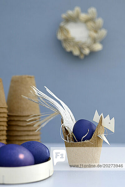 Purple Easter eggs and hen made of biodegradable flower pot
