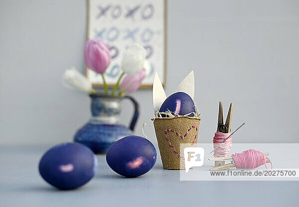 Studio shot of purple Easter eggs and homemade decorations