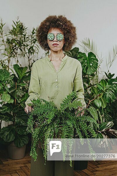 Woman wearing echeveria eyeglasses near plants
