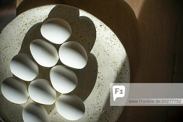 Easter eggs arranged in plate on table at home