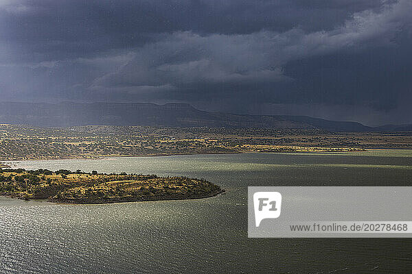 Usa  New Mexico  Abiquiu  Sun shining through storm clouds over Abiquiu Lake