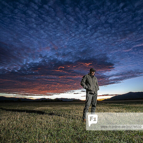 USA  Idaho  Bellevue  Farmer standing in field at sunrise