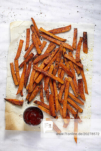 Overhead view of sweet potato fries and small bowl of ketchup