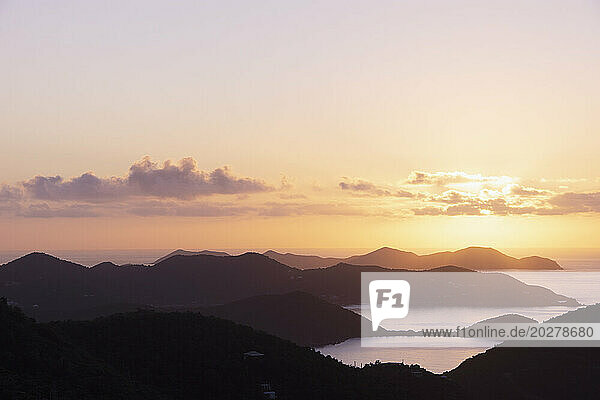 USA  United States Virgin Islands  St. John  Golden sunrise over calm Caribbean Sea