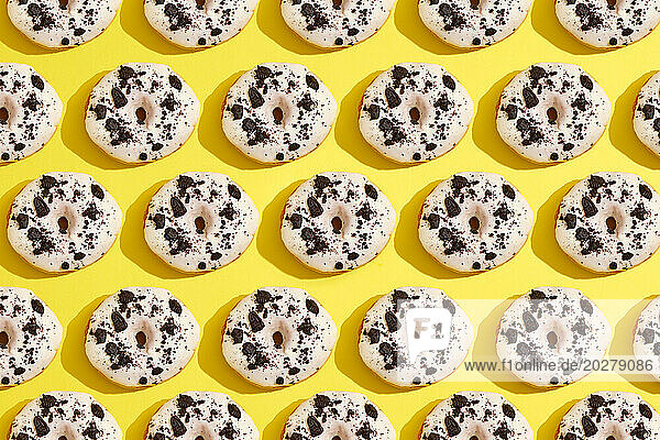 A pattern of donuts on a yellow background