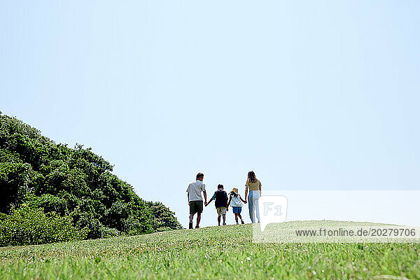 A family walking on a grassy hill