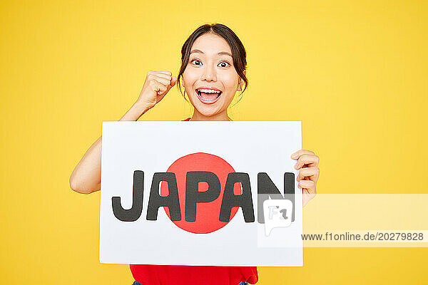 Asian woman holding Japan sign
