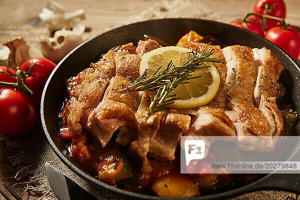 Eine Pfanne mit Hühnergemüse und Tomaten