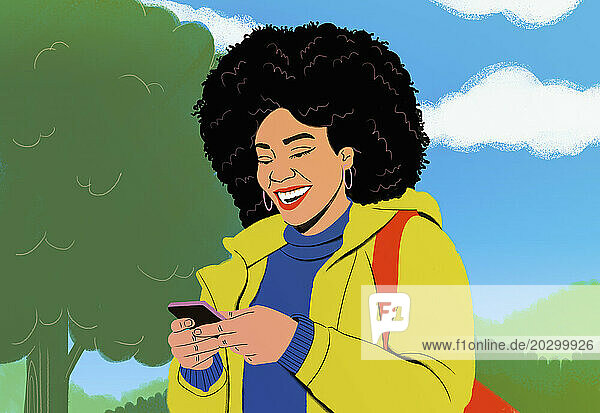 Happy young woman with afro texting with smart phone in park