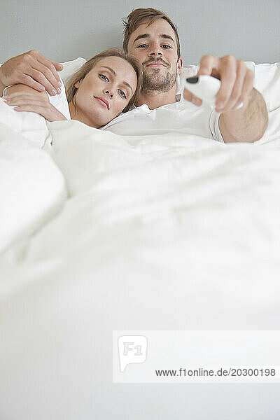 Couple in Bed Watching TV