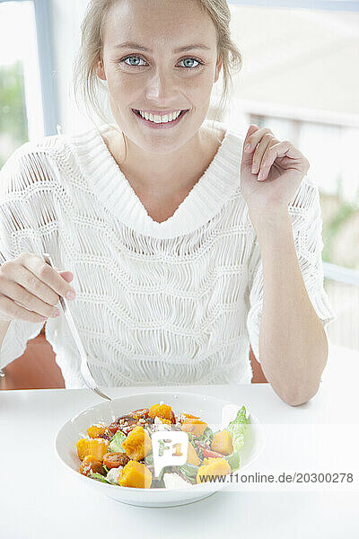 Smiling Woman Eating Salad