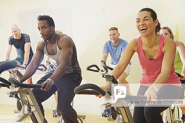 Group of People Using Exercise Bicycles at Fitness Class