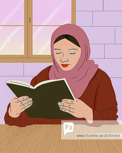 Muslim woman in hijab reading book at table