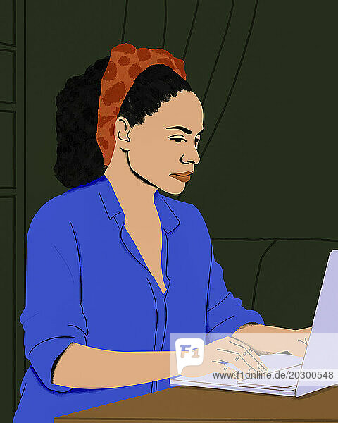 Focused woman working from home at laptop