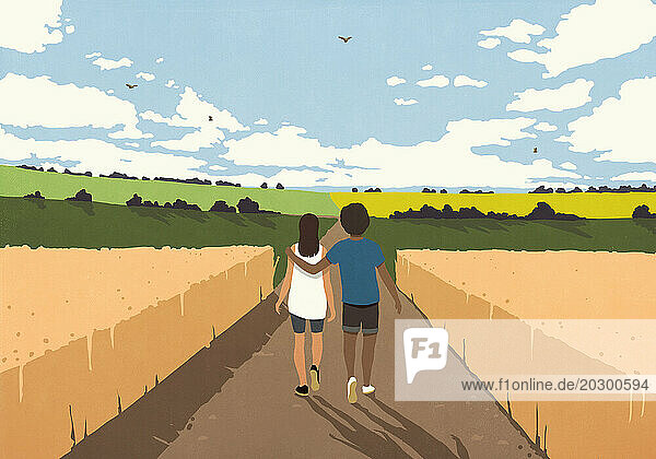 Affectionate couple walking among crops in sunny  rural countryside