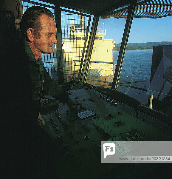 Australia. Industry. Docks. Crane control operator.