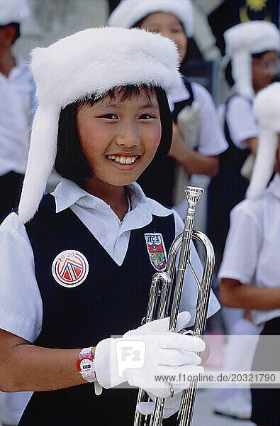 Malaysia. Kuala Lumpur. Independence Day Festival. Children. Young girl with trumpet.