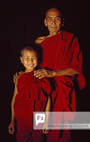 Myanmar. Portrait of Buddhist monk and child novice.