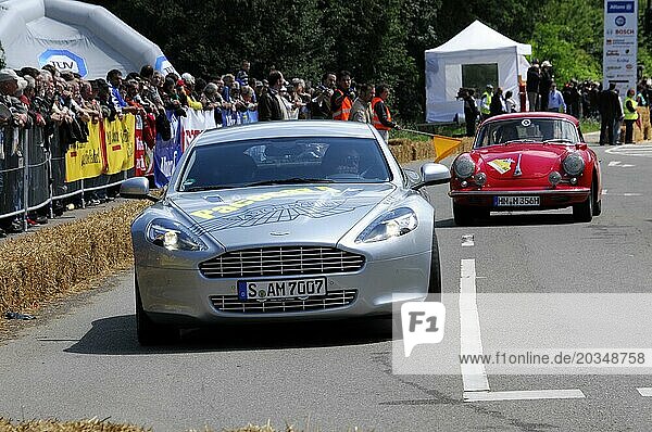 Silver Aston Martin leads a red Alfa Romeo in a classic car race  SOLITUDE REVIVAL 2011  Stuttgart  Baden-Württemberg  Germany  Europe