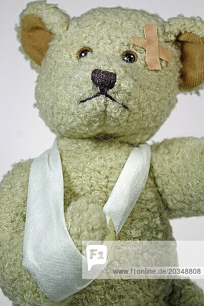 Injured teddy bear with arm sling