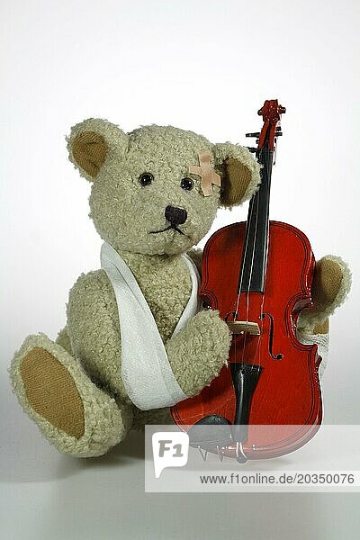 Injured teddy bear making music