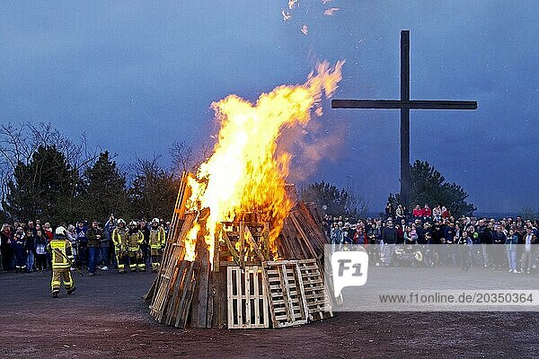 The fire brigade has lit the Easter bonfire on the Haniel spoil tip in front of the summit cross  Bottrop  Ruhr area  North Rhine-Westphalia  Germany  Europe