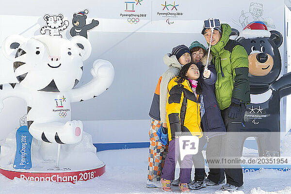 Family taking group selfie in Alpensia Resort  with two mascots  Gangwon-do  South Korea