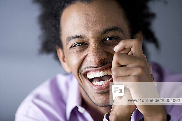 African American man with huge afro smiles