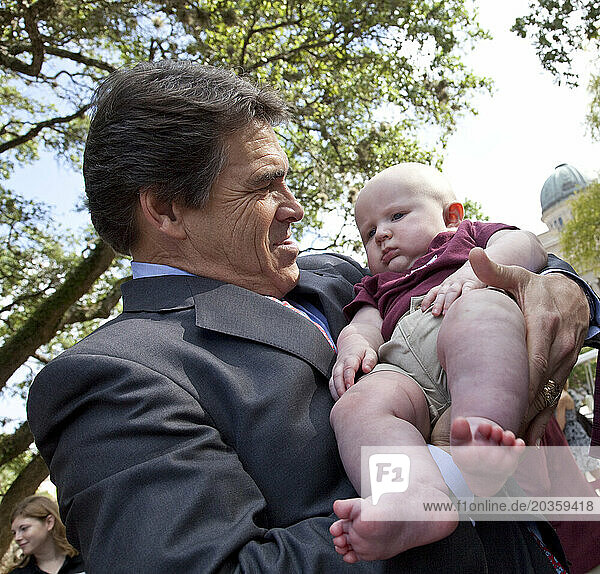 Texas Governor and 2012 Republican Presidential Candidate  Rick Perry  poses for a photo op with a baby.