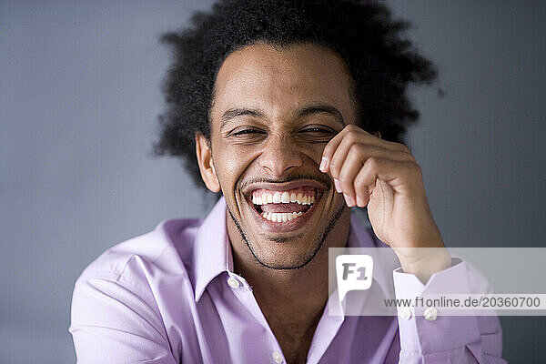 African American man with huge afro smiles.