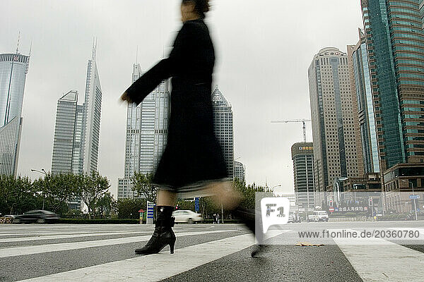 Worker on her pedestrian commute  Shanghai  China.