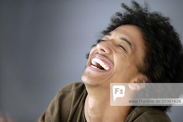 African American man with huge afro smiles.